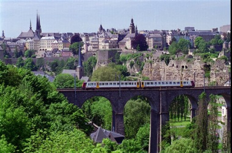Luxemburg's old town skyline is seen from across the deep gorge that runs through the city in July, 1996. The Grand Duchy of Luxembourg doesn’t get a lot of turns in the spotlight. It’s an independent country tinier than Rhode Island, the smallest U.S. state, and it would fit inside Germany, its neighbor to the east, 138 times with room to spare. It won no medals at the 2012 London Olympics; its only gold came at the 1952 Helsinki Games, in the men’s 1,500 meters. But this week is Luxembourg’s turn to shine. Prince Guillaume, the heir to the throne _ the grand duke-to-be _ will marry the Belgian Countess Stephanie de Lannoy. It will be a two-day affair, including fireworks, concerts, a gala dinner at the grand ducal palace, and two marriages between the betrothed _ a civil wedding Friday afternoon and a religious ceremony Saturday morning.   (AP Photo/Paul Ames)